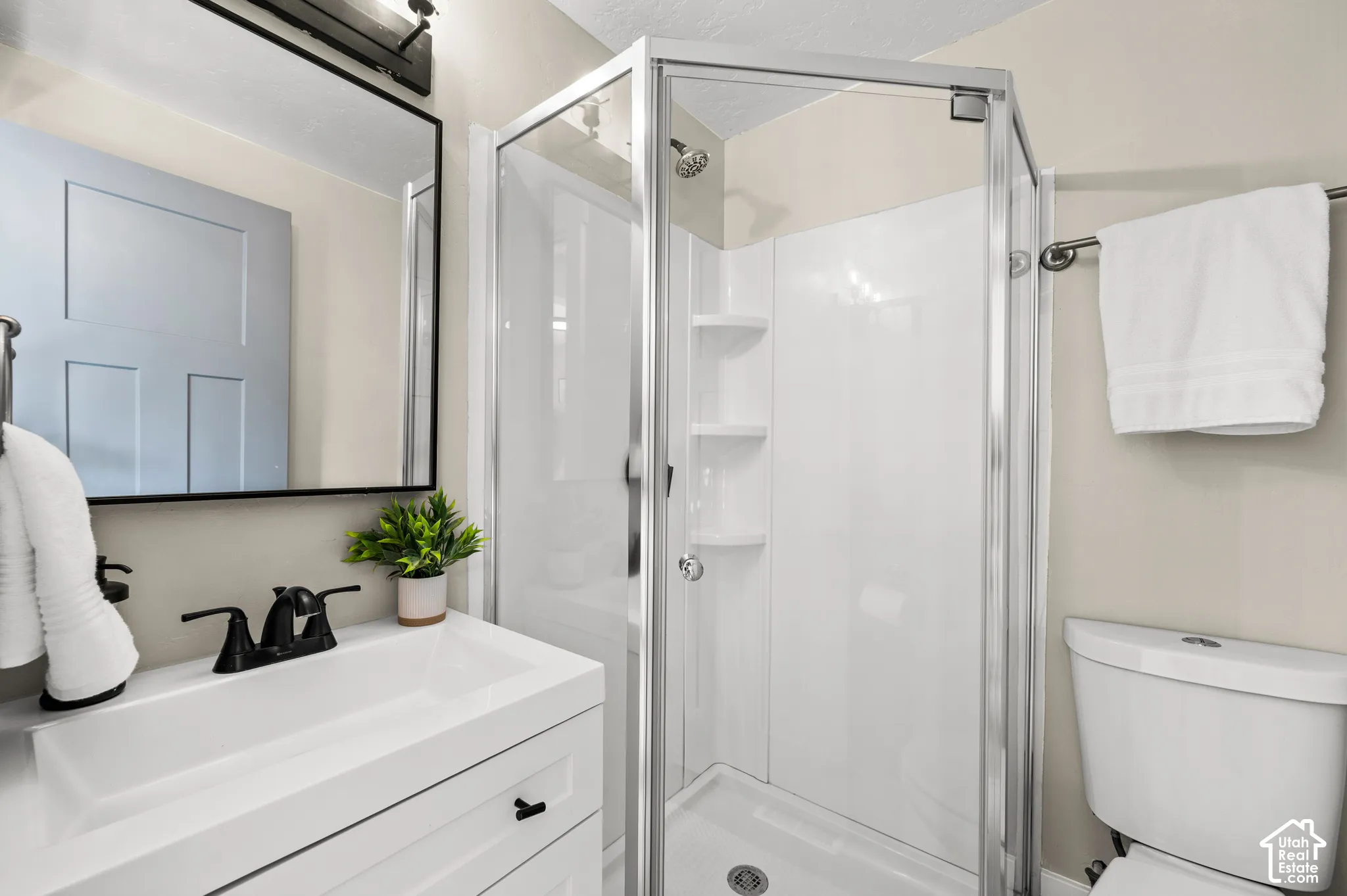 White vanity with integrated sink and matte black faucet