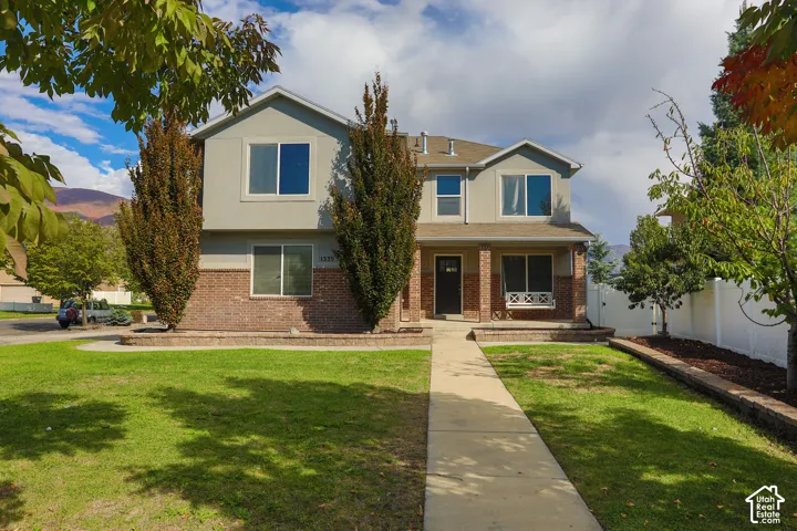 Two-story residence featuring a brick and siding exterior