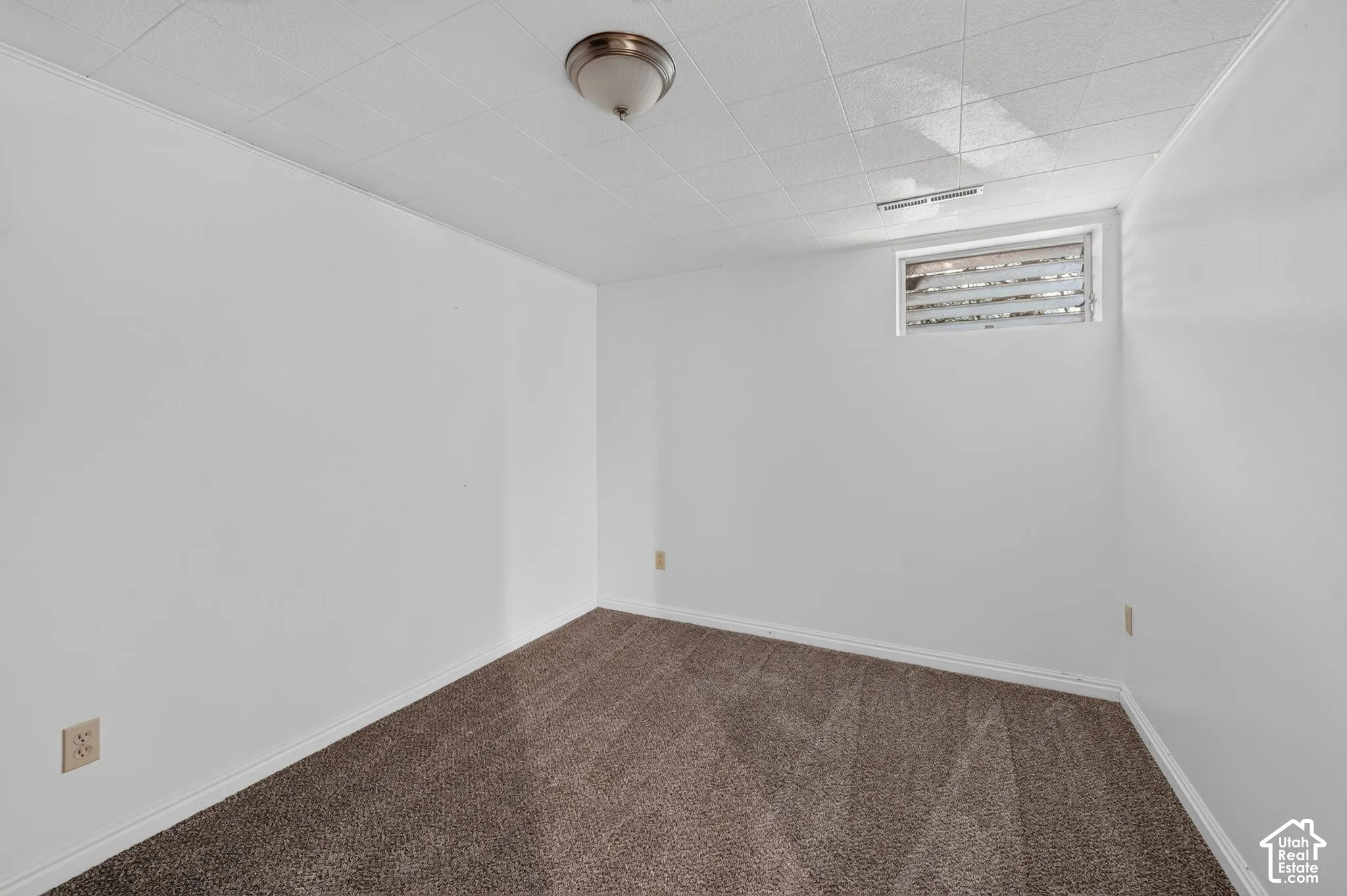 Finished basement room featuring neutral wall finishes, recessed ceiling lighting, and neutral-tone carpeting