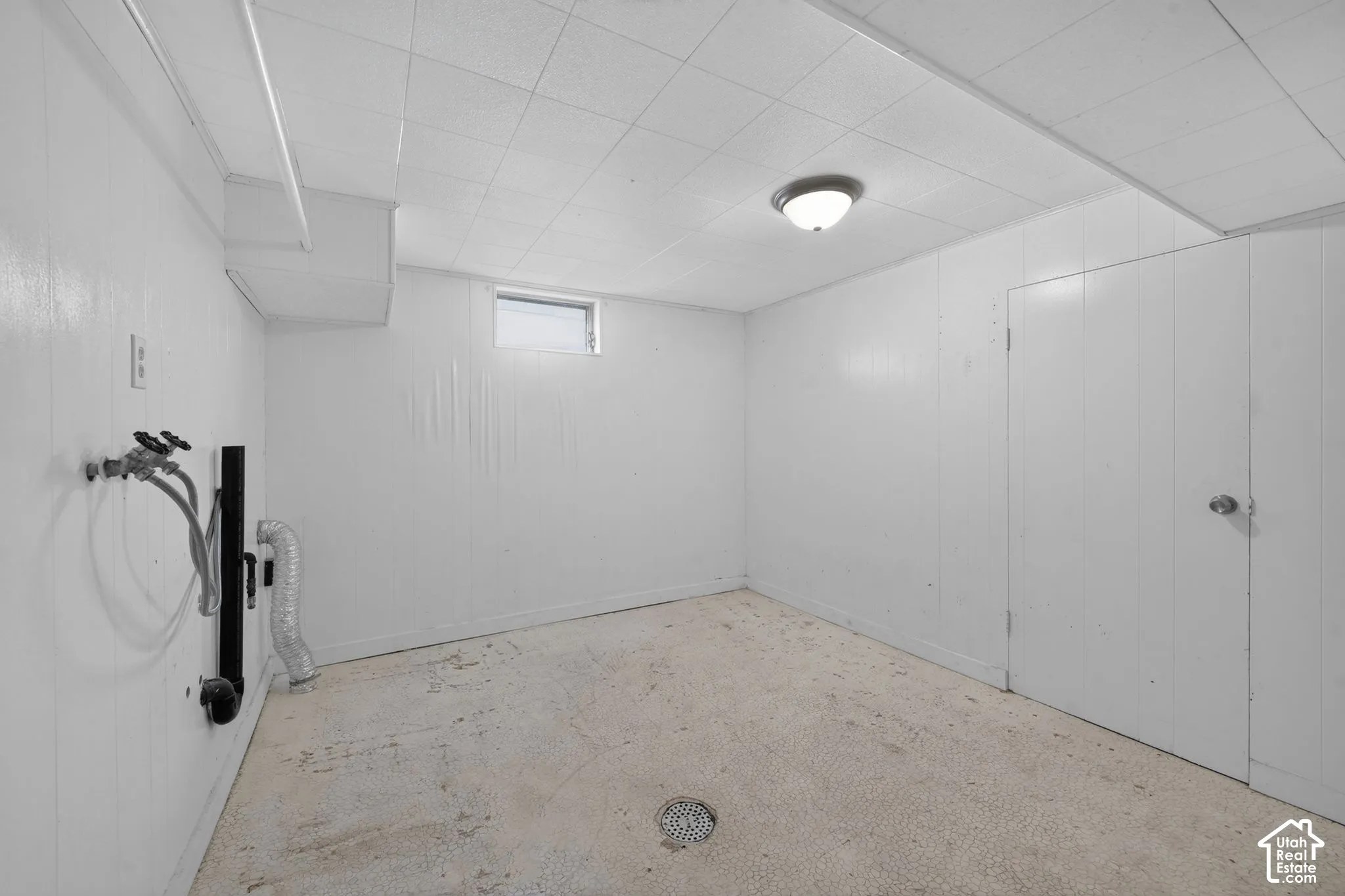 Finished basement featuring clean white drywall, concrete flooring, and recessed ceiling lighting