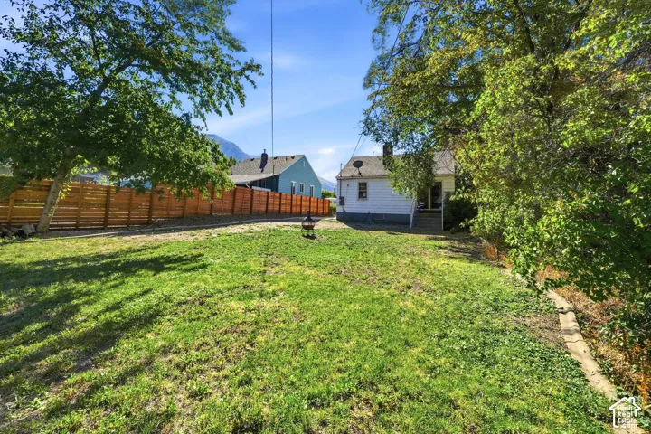 Expansive lawn area with a new horizontal plank fence and mature trees