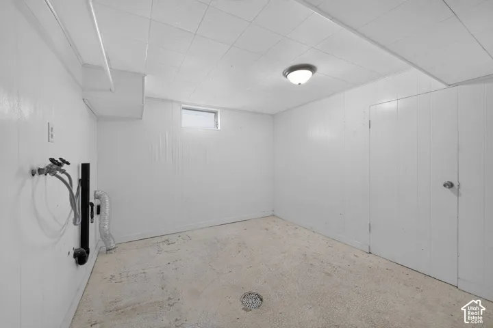 Finished basement featuring clean white drywall, concrete flooring, and recessed ceiling lighting