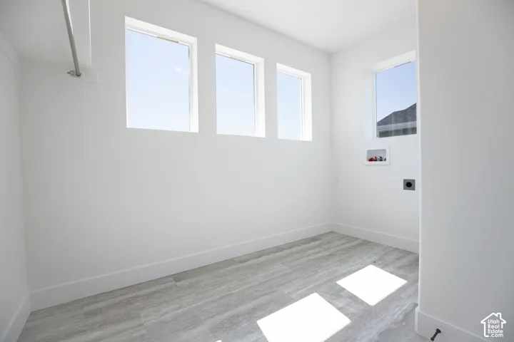 Full-size, dedicated laundry room with natural light and washer/dryer hookups.
