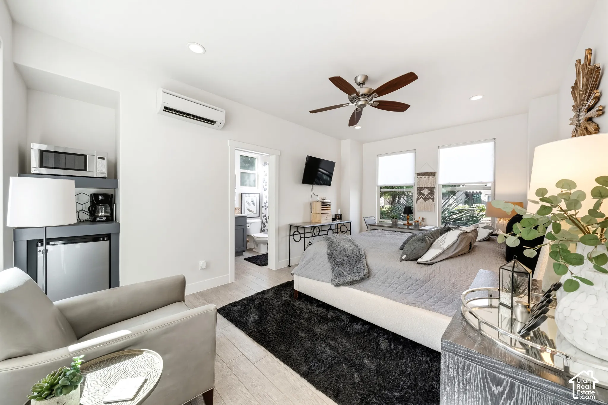 Recessed lighting, wood-finish flooring, ceiling fan, built-in shelving, and a mini-split HVAC system