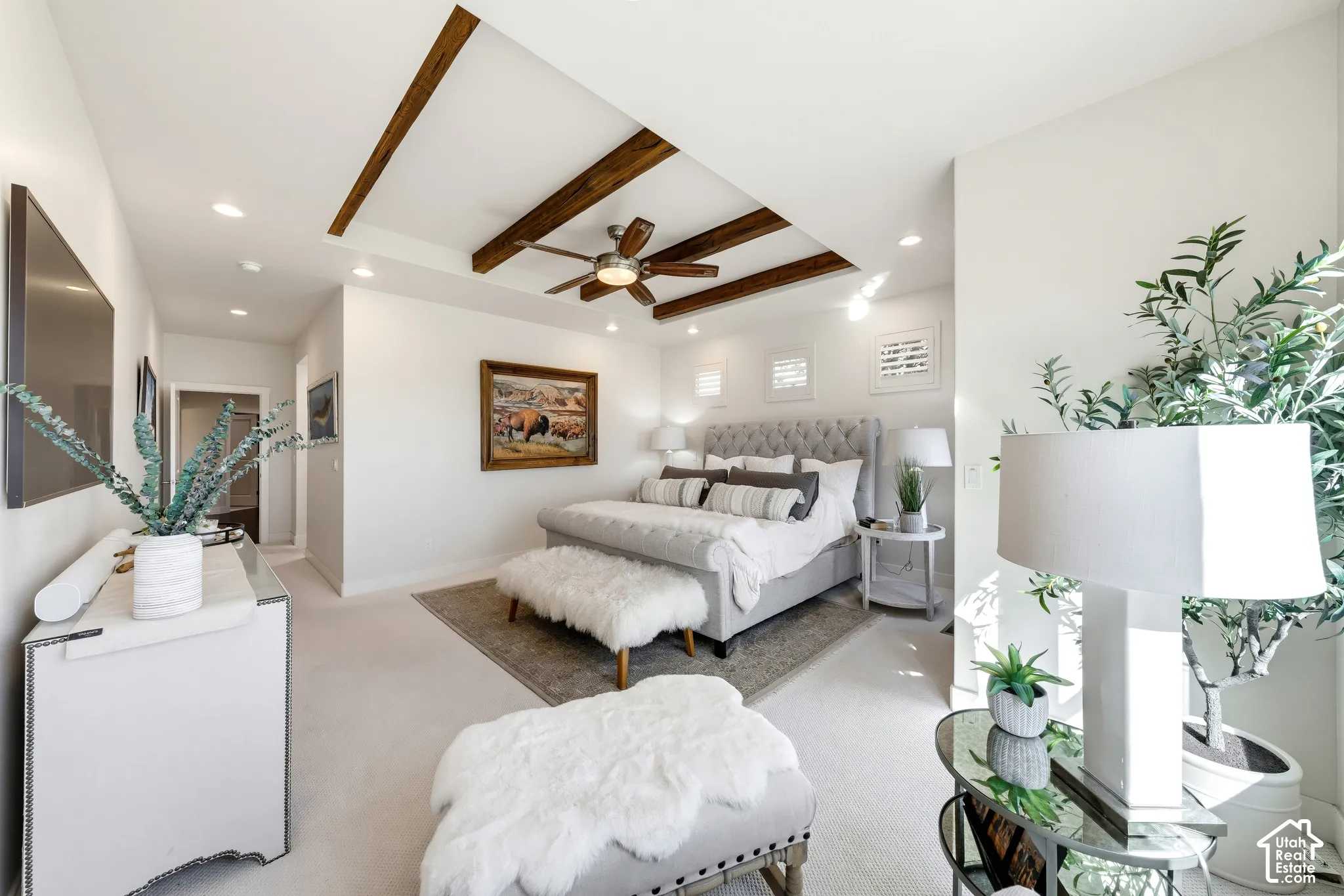 Recessed lighting, ceiling fan, wood-beam ceiling, and broadloom carpeting