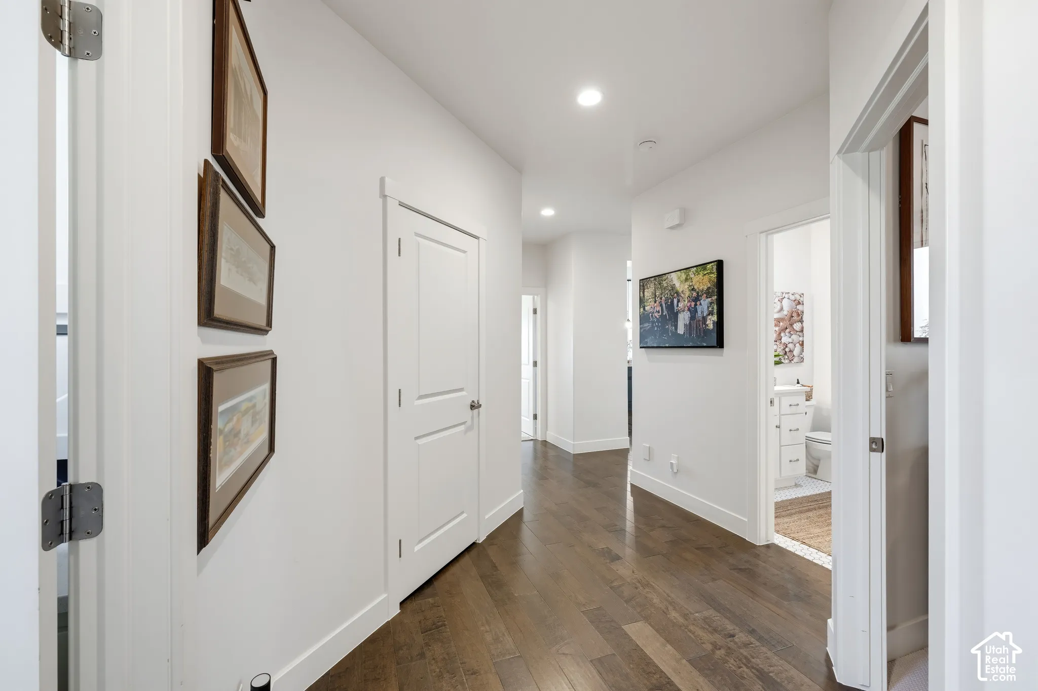 Wood-finish flooring, recessed lighting, white walls, and white trim