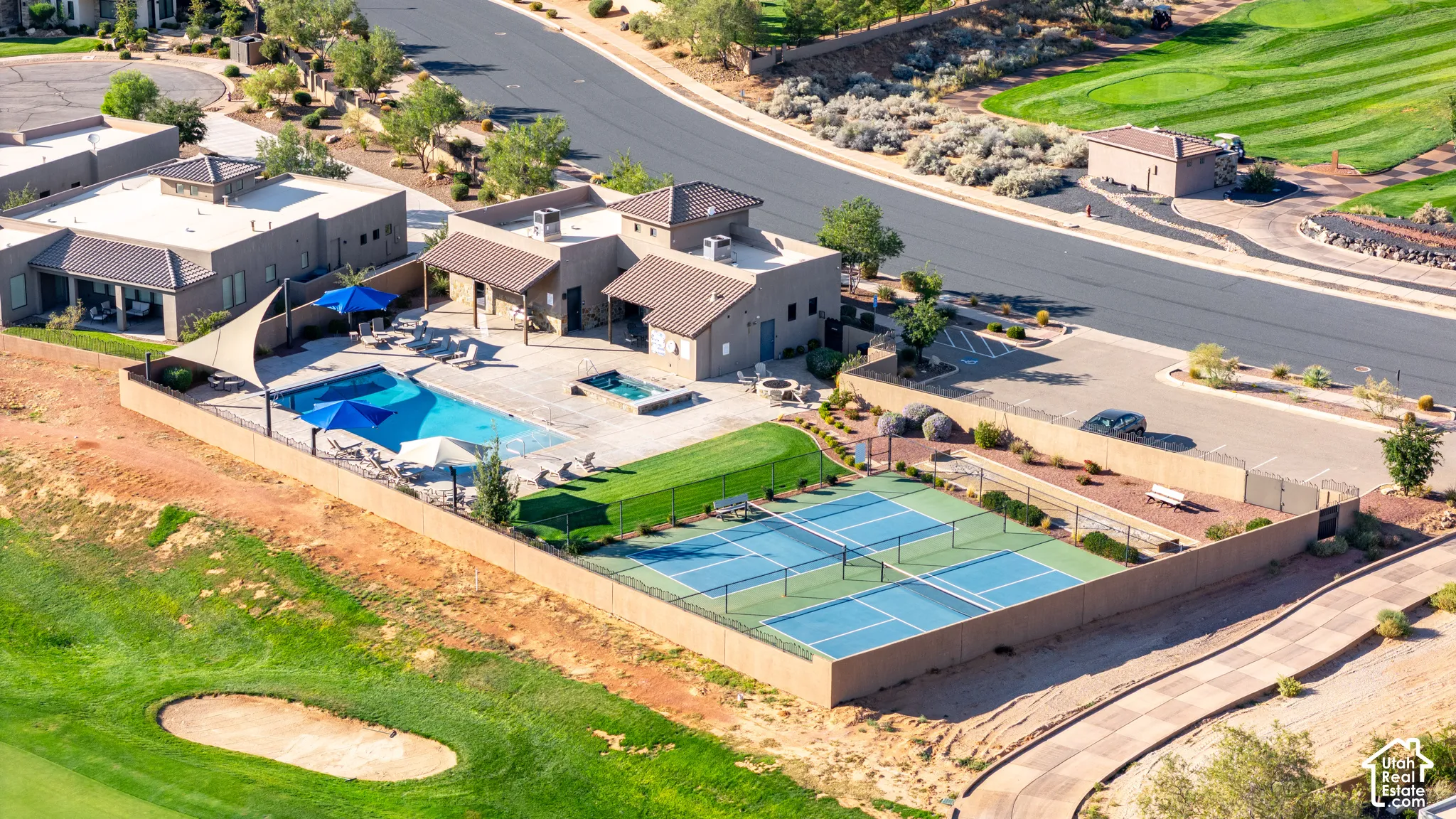 Community amenities featuring multiple tennis courts, a swimming pool, and a spa area with surrounding structures