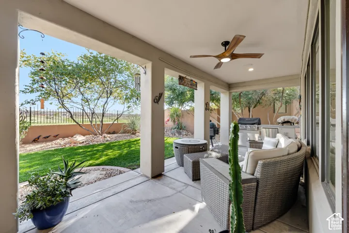 Covered patio with a ceiling fan, recessed lighting, and an outdoor kitchen area