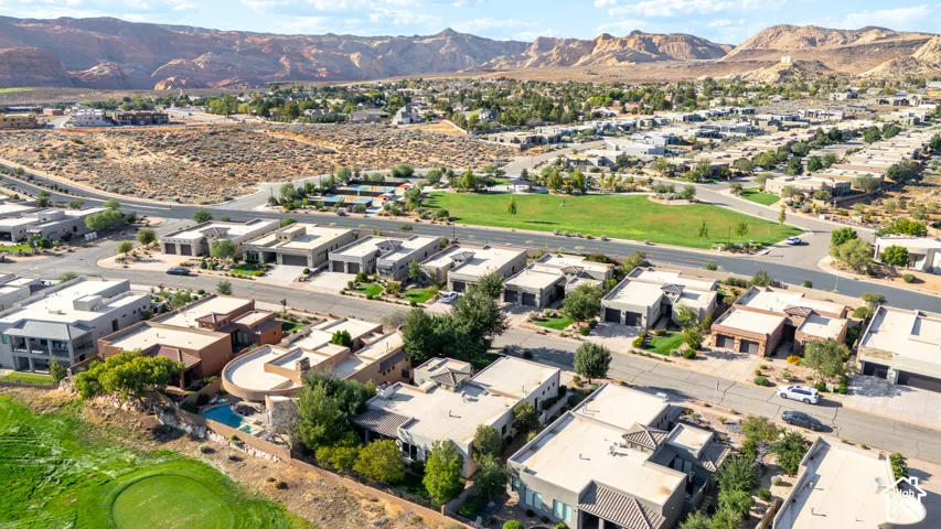 Aerial view showcasing a contemporary residential community nestled within a scenic valley landscape