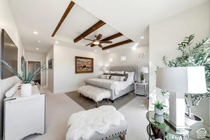 Recessed lighting, ceiling fan, wood-beam ceiling, and broadloom carpeting