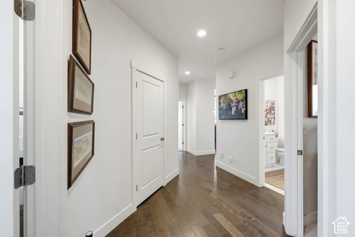 Wood-finish flooring, recessed lighting, white walls, and white trim