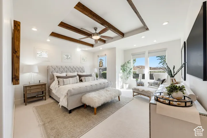 Coffered ceiling with exposed wood-finish beams, recessed lighting, ceiling fan, and large windows with roller shades