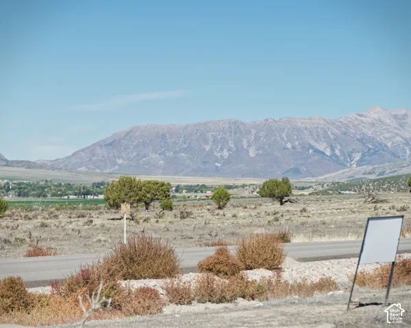 Expansive land parcel featuring distant mountain ranges and a clear sky