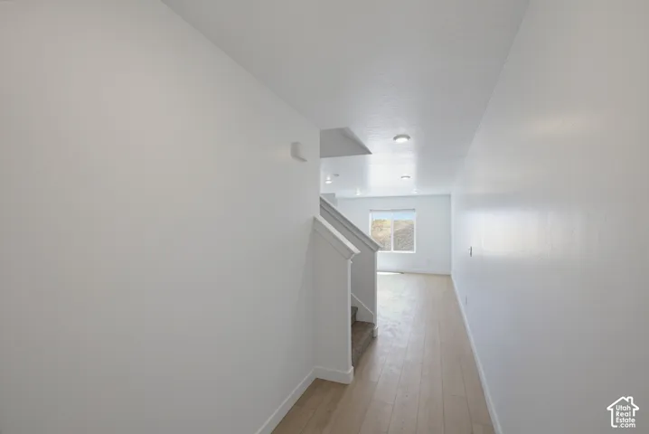 Entryway featuring light wood-finish flooring, white walls, and recessed lighting