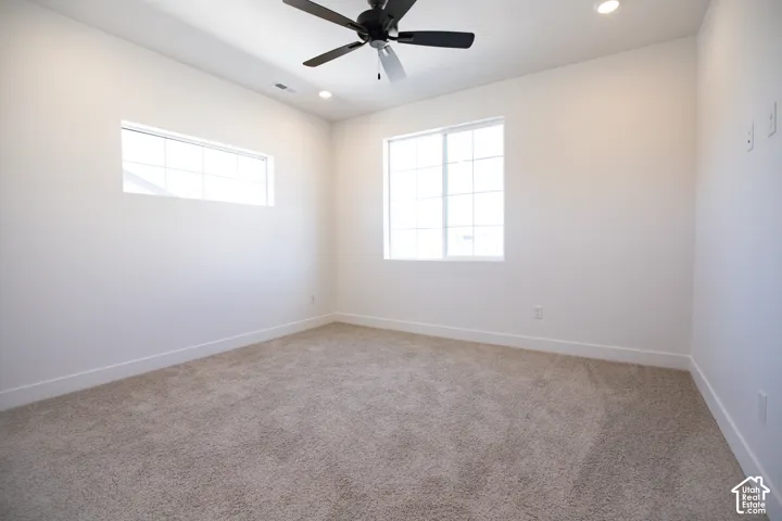 Primary bedroom with ceiling fan.