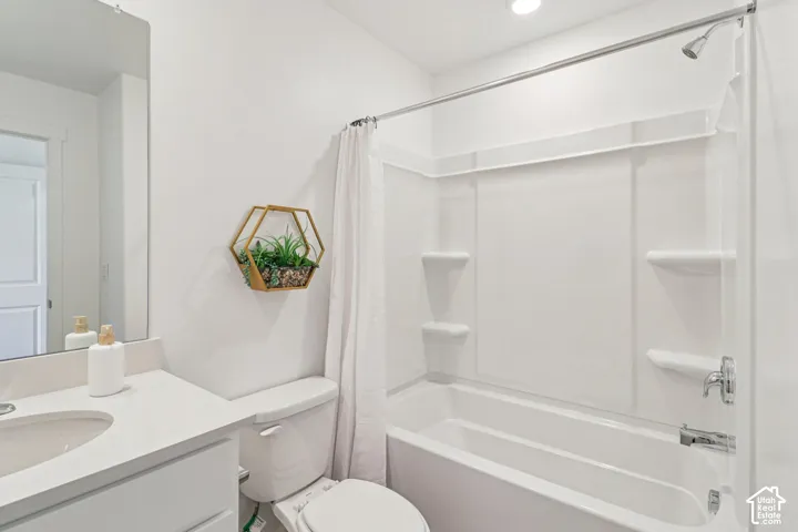 White vanity with an integrated sink, polished chrome faucet, and a large wall-mounted mirror
