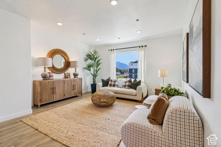 Recessed lighting, wood-finish flooring, and a window with mountain scenery