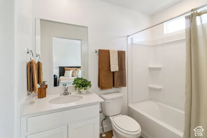 White vanity with a single basin sink, chrome faucet, and integrated countertop