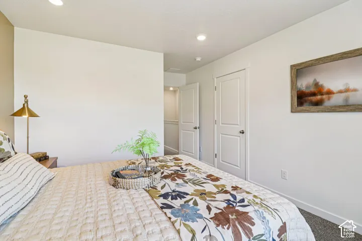Neutral wall tones, white trim, recessed lighting, and carpeted flooring