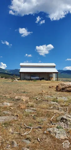 Metal-sided structure featuring an extended covered area and a metal roof