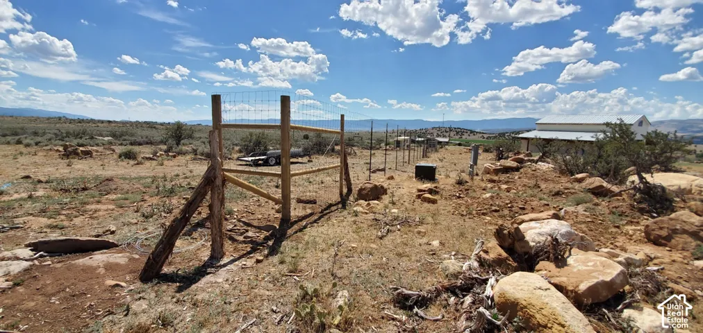 Fenced perimeter with wood posts and wire mesh