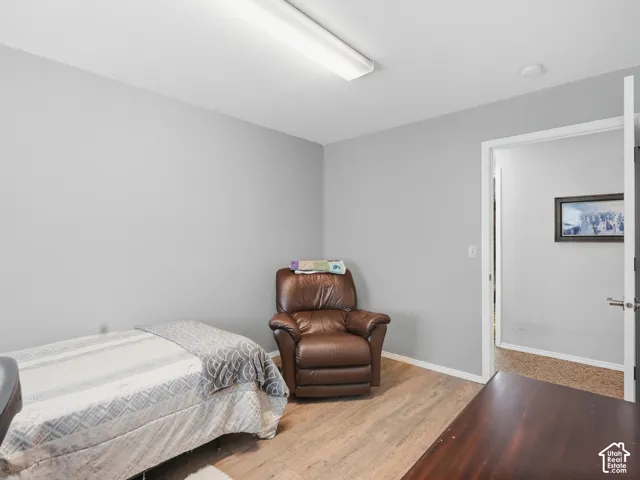 Wood-finish flooring, light gray wall paint, and a flush-mounted ceiling light fixture