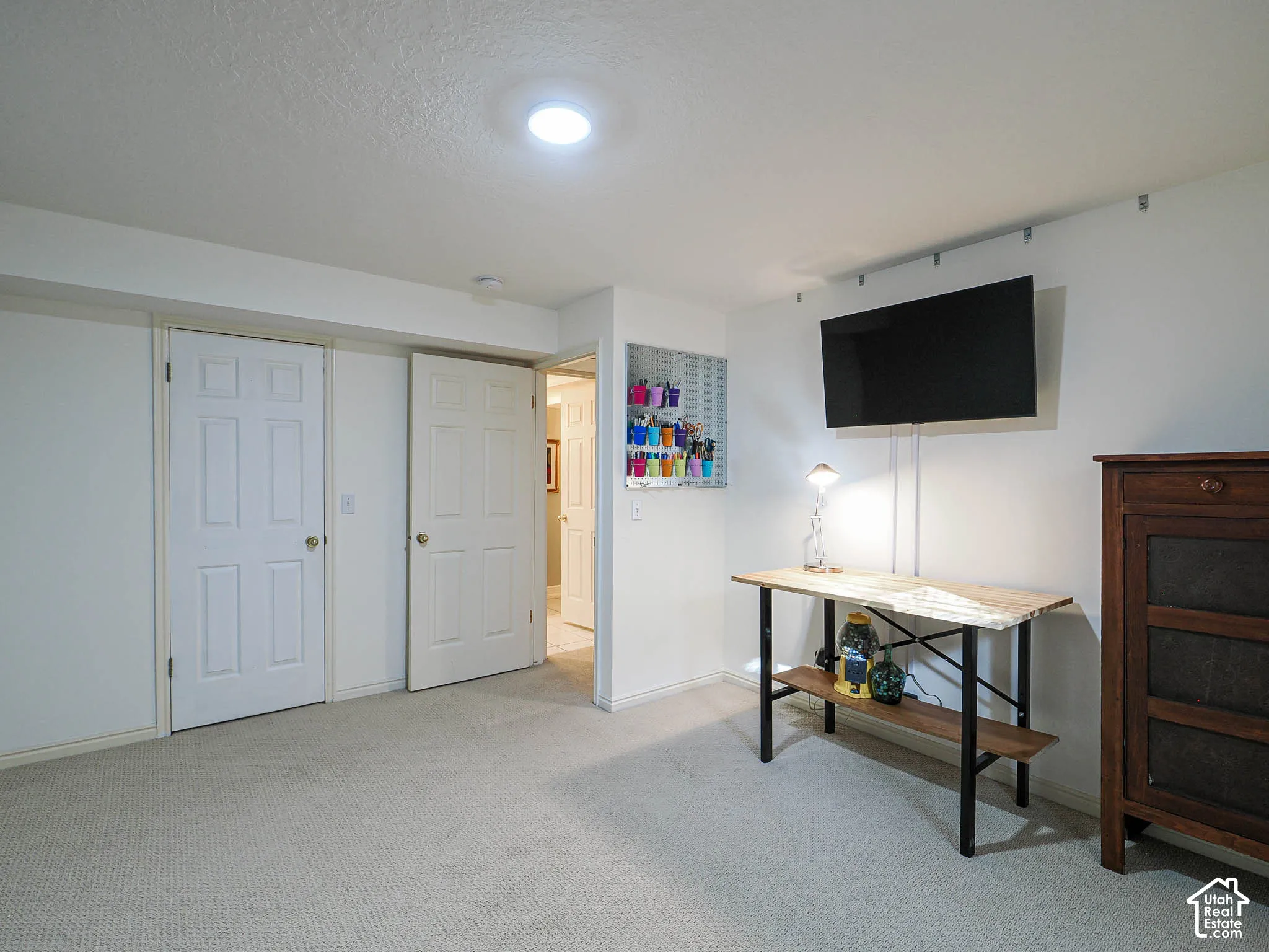 Recessed lighting, light-toned carpet flooring, and white interior doors
