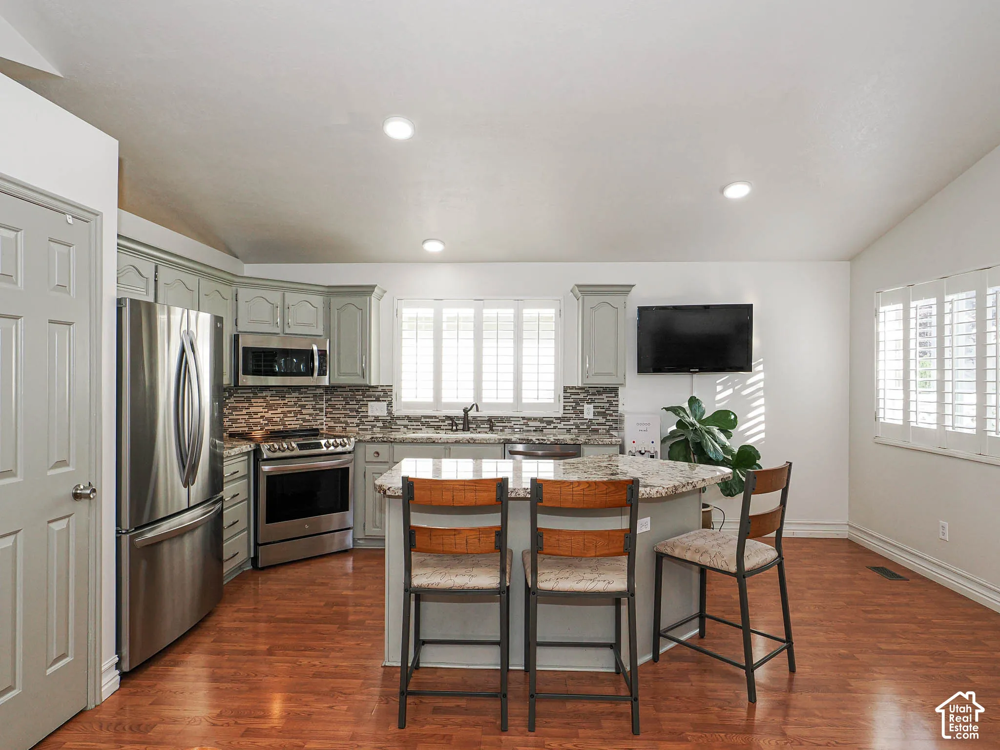 Wood-finish flooring, recessed lighting, and vaulted ceiling