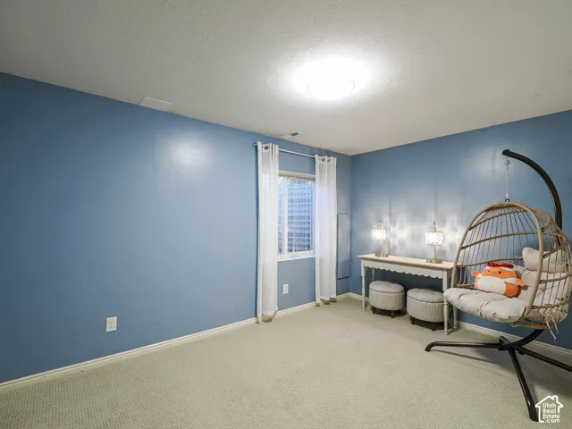 Recessed window, ceiling-mounted light fixture, and light-toned carpet flooring