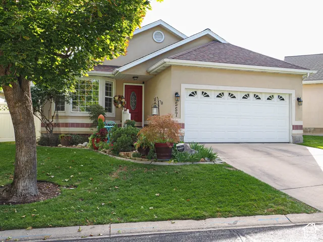 Stucco exterior with a red entry door and a two-car garage