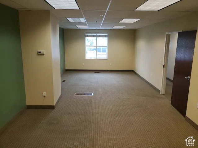 Spacious room featuring carpeting, recessed lighting, and a single window