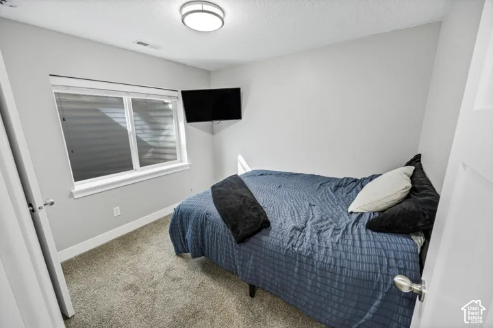 Recessed window with white trim, wall-mounted television, and flush-mount ceiling light