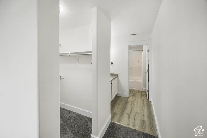 Walk-in closet with shelving and hanging rod
