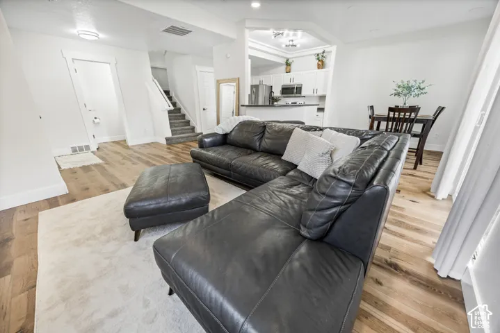 Wood-finish flooring throughout, with a carpeted staircase