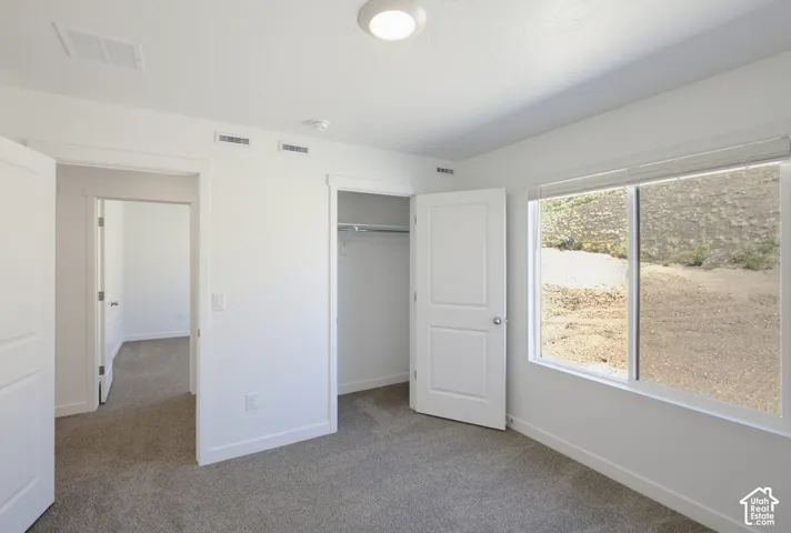 Recessed lighting and a spacious closet with built-in shelving