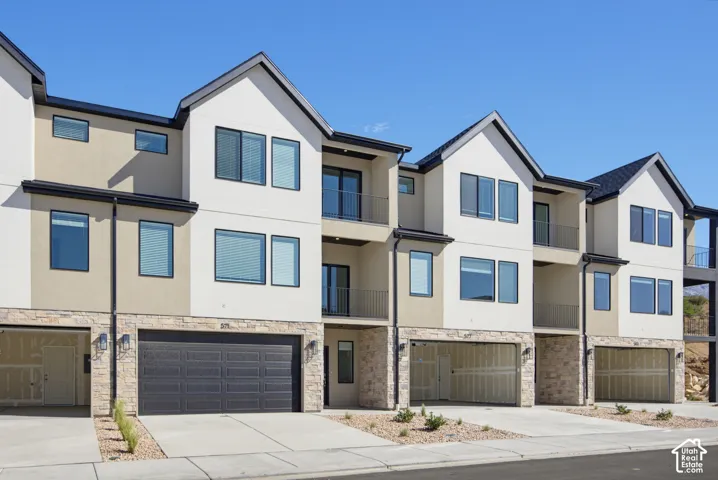 Contemporary multi-story exterior with stone veneer and stucco finishes