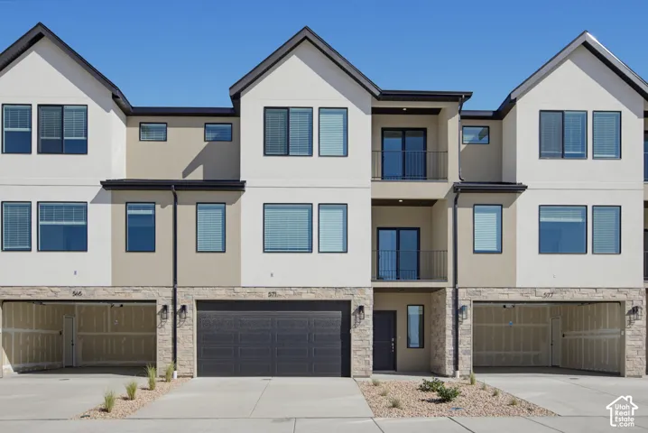 Contemporary facade featuring multi-tone stucco and stone accents