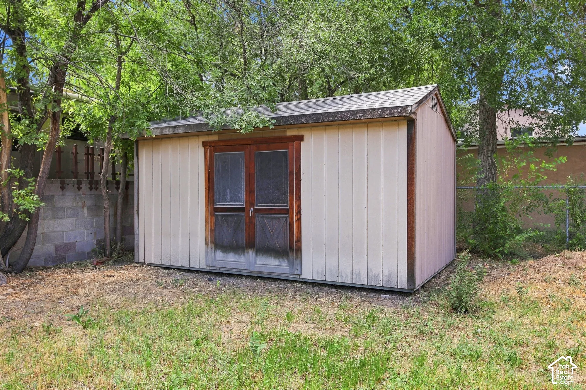 Exterior shed with a pitched roof and double doors