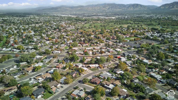 Expansive residential area with a diverse collection of homes, mature trees, and a mountain backdrop