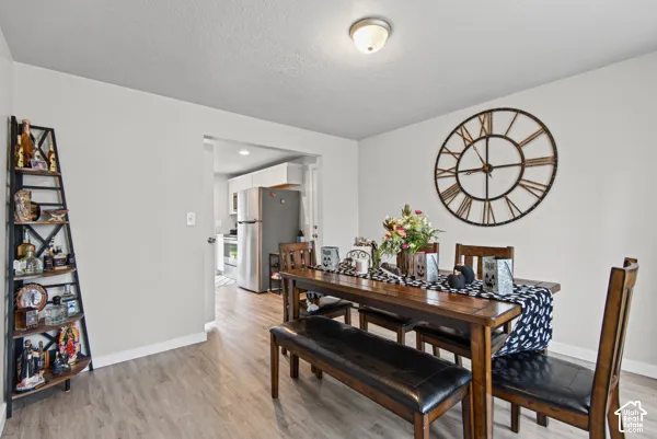 Wood-finish flooring throughout, light neutral wall tones, and recessed ceiling lighting