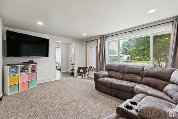 Recessed ceiling lighting, light gray wall paint, and gray carpeting