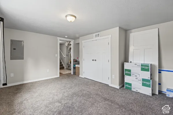 Carpeted room with light grey walls, white trim, and a flush-mount ceiling light fixture