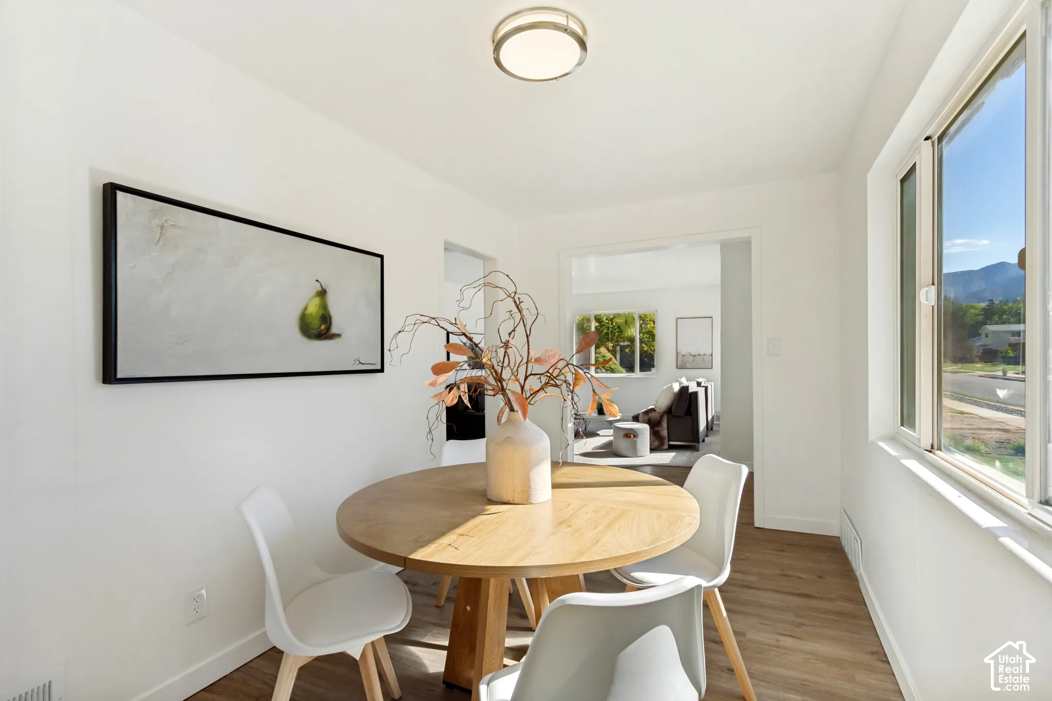 Bright interior with wood-finish flooring, recessed lighting, and large windows providing ample natural light
