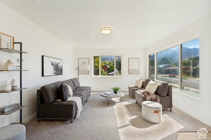 Bright living space with large windows, recessed lighting, and light-toned wall finishes