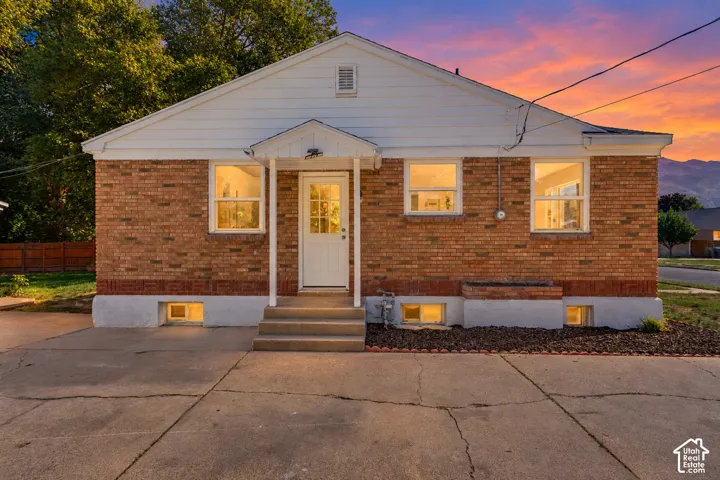 Brick exterior with white siding and a covered front entry