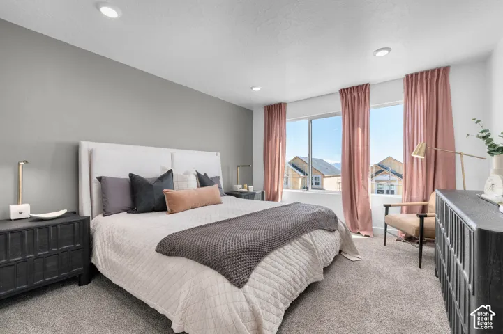 Recessed lighting, wall-to-wall carpeting, and expansive windows