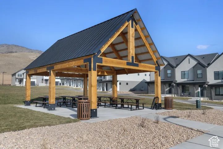 Community pavilion featuring a metal roof, exposed timber framing, and a concrete pad