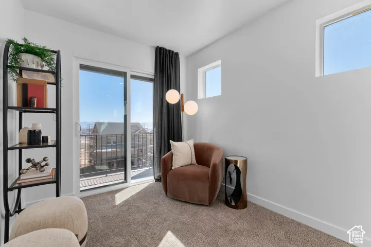 Sliding glass door leading to a balcony with a wrought iron railing