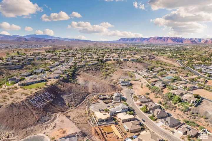 Expansive neighborhood with diverse architecture, arid landscaping, and distant mountain ranges