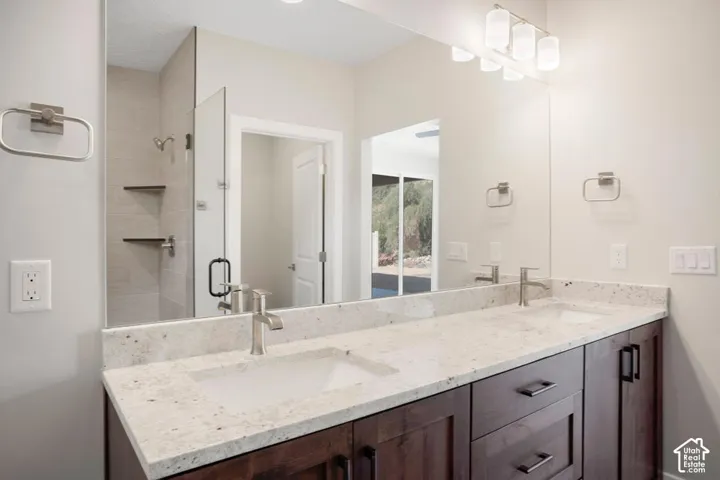 Dual vanity with integrated sinks, brushed nickel fixtures, and a light-toned countertop